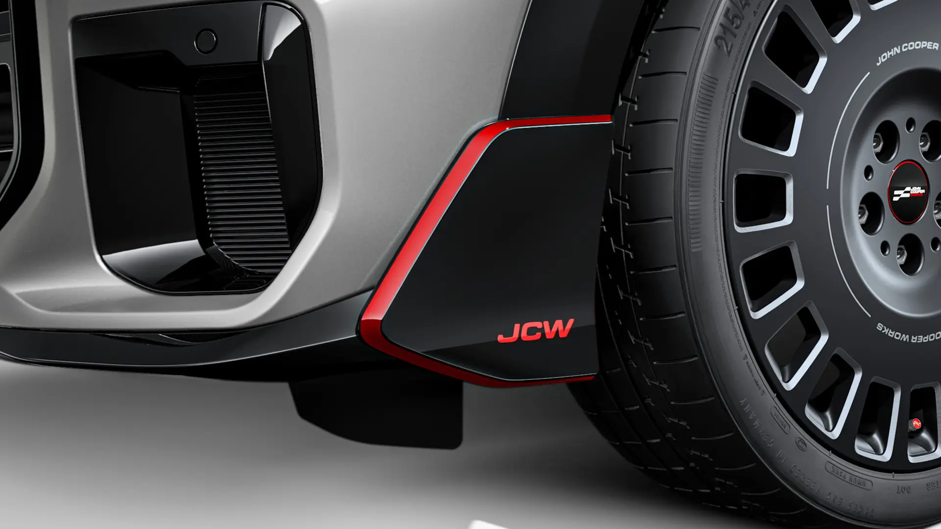 MINI John Cooper Works frontvinge i svart høyglans med JCW bokstaver og dekorstriper.